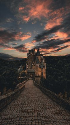 an image of a castle in the sky with clouds above it and a green door