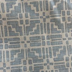 an upholstered fabric with blue and white squares on it's surface, closeup