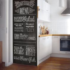 a kitchen with a chalkboard menu on the wall next to a stove top oven