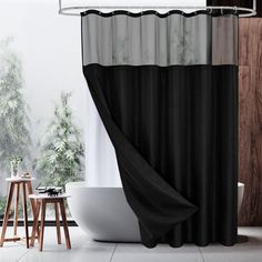 a bathroom with a bathtub, toilet and shower curtain in black and white colors