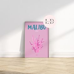 there is a pink poster on the wall in front of a white wall and wood floor