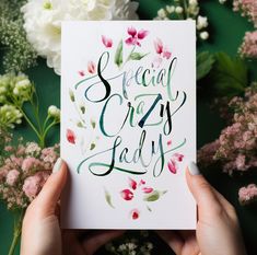 someone holding up a greeting card with the words special crazy lady written in green ink