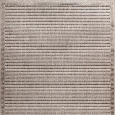 an area rug with lines and dots on the bottom, in neutral colors is shown