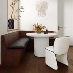 there is a white table and two chairs in the room with wood flooring on the walls