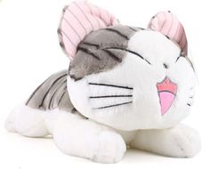 a white and gray cat stuffed animal with pink ears on it's head, laying down