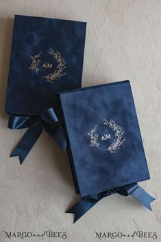 two blue boxes with ribbons tied around them