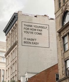 a sign on the side of a building that says, thank yourself for how far you've come it hasn't been easy