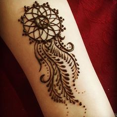 a woman's arm with hendix on it and an intricate design in the middle