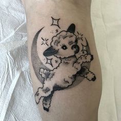 a black and white tattoo of a dog flying in the sky with stars on it