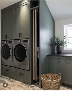 a washer and dryer in a laundry room next to cabinets with doors open