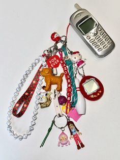 a cell phone laying on top of a bunch of key chains