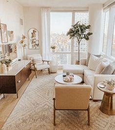 a living room filled with furniture and a large window covered in cityscape behind it