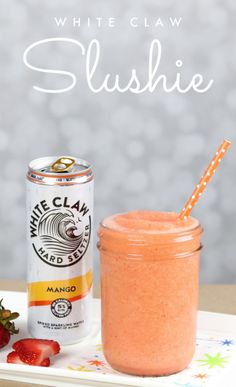 a can of white claw slushie next to strawberries on a tray with a straw in it