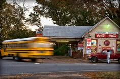 a school bus passing by a gas station