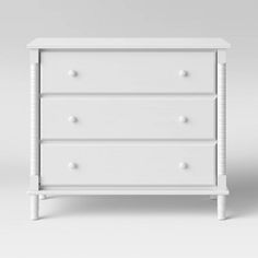 a white dresser with three drawers