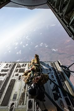 the view from inside an aircraft looking down at some people on it's side