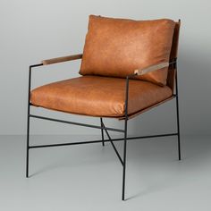 a brown leather chair with black metal frame