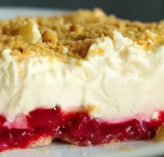 a close up of a dessert on a plate with crumbs and toppings