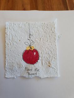 a piece of paper with a drawing of a red apple and the words plant me home on it