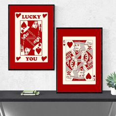 two framed playing cards with the words lucky and you on them are sitting on a table