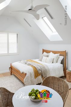 an attic bedroom with white walls and wooden furniture