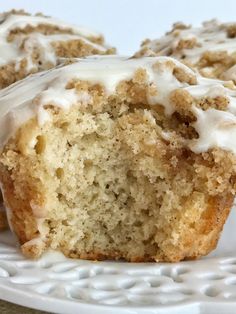 a muffin with white icing sitting on a plate