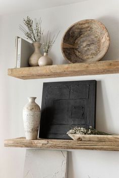 two wooden shelves with vases and other items on them