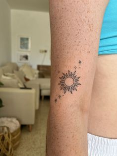 a woman's arm with a tattoo on it that shows the sun and stars