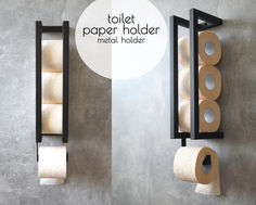 two toilet paper holders with rolls of toilet paper hanging on the wall next to them