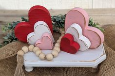 two wooden hearts sitting on top of a table