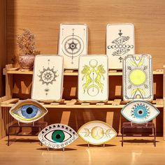 an assortment of decorative plates on display in a wooden case with eyeballs and stars