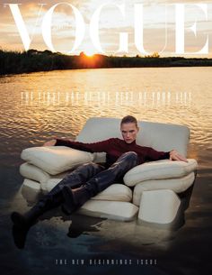 a man laying on top of a white couch in the middle of a body of water