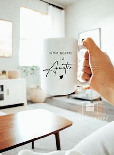 a person holding a white coffee mug with the words from bestie to annie on it