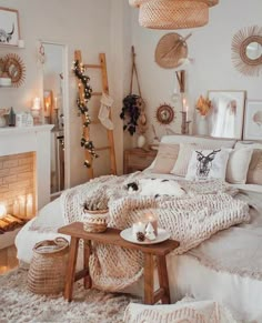 a bed with blankets, pillows and candles in a room decorated for christmas or new year's eve