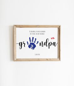 a wooden frame hanging on the wall with a handprint that says grundup