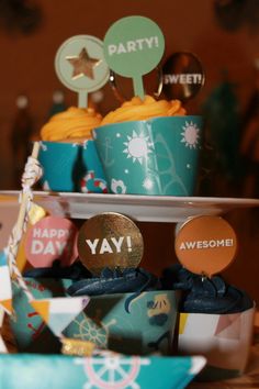 some cupcakes that are sitting on top of a cake platter with happy birthday decorations