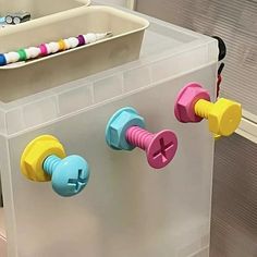 a plastic container with some colorful knobs on it