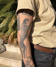 a man with a leopard tattoo on his arm