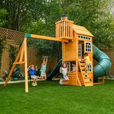 children playing in the backyard on a wooden swing set