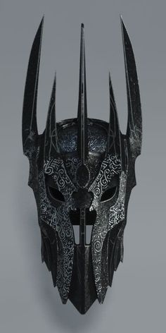 a helmet with horns on it is shown in black and silver colors, as well as an image of a demon's head