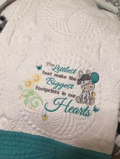 a quilted blanket with an elephant on it that says, the smallest things in the biggest moments are footprints in our hearts