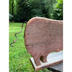 an old wooden bench sitting in the grass