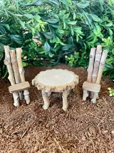 two chairs and a table made out of logs