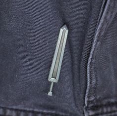 there is a small metal object in the pocket of a pair of blue sweatpants