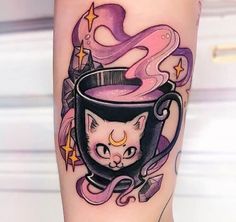 a cat in a cup tattoo on the leg