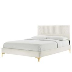 a white bed with gold legs and headboard on it's side, in front of a white background