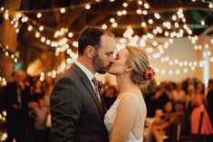 a bride and groom kissing at their wedding reception