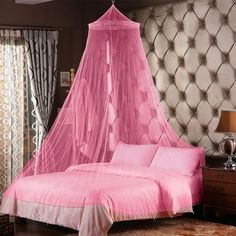 a bed with a pink canopy over it