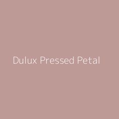 the words dulux pressed petal are in white letters on a pale pink background