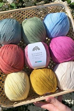 several balls of yarn are in a basket